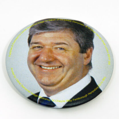 Round badge with picture of Alistair Carmichael